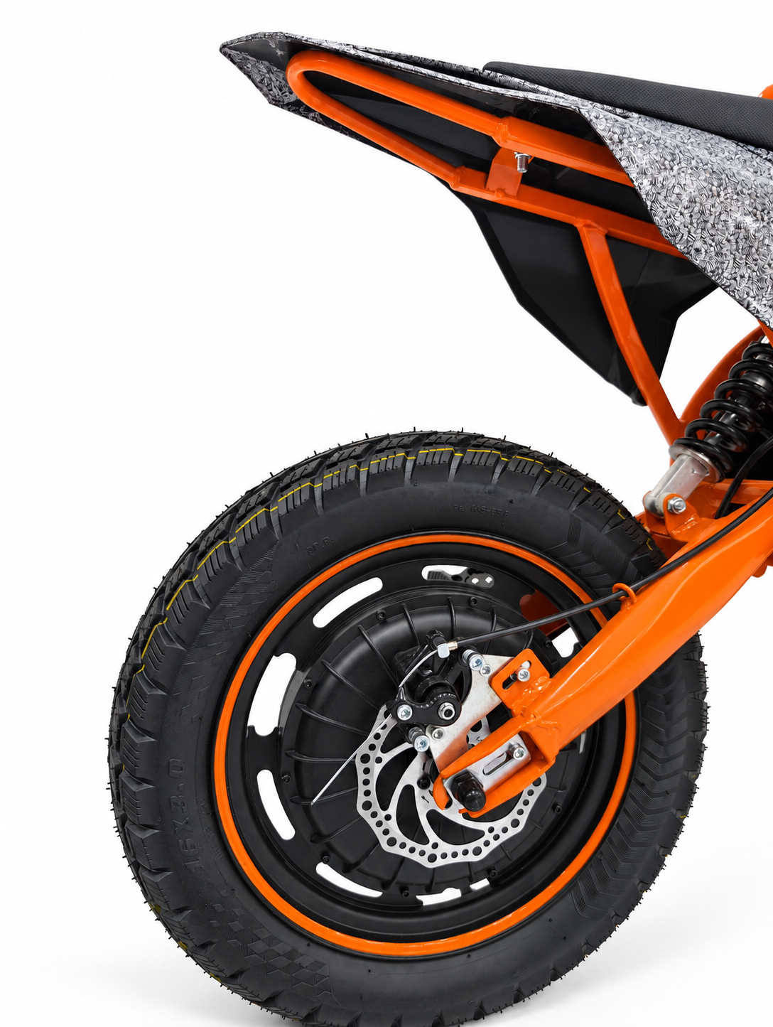 AK7 GTM 3 Orange kids electric dirt bike – rear wheel, disc brake and suspension close-up on a white studio background