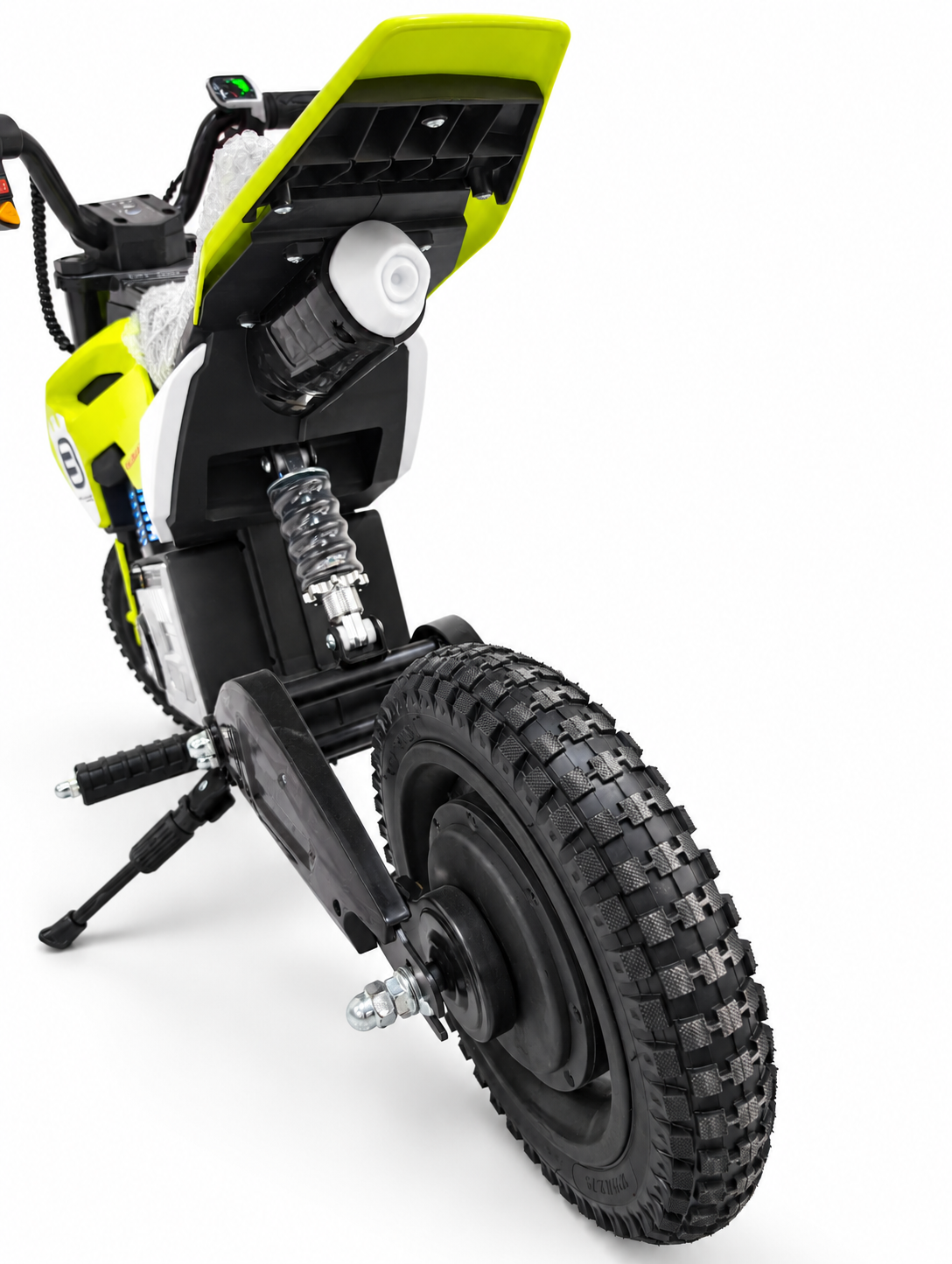 Lime green kids electric dirt bike – rear tyre and spring suspension close-up
